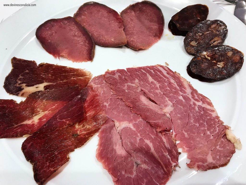 Siguiendo el sentido de las agujas del reloj: lengua de vaca de 12 meses de maduración, chorizo de buey de 12 meses de curación, pastrami de 8 meses de maduración y cecina de 20 y 12 meses de maduración. Copyright: Alicia Gómez para www.devinosconalicia.com